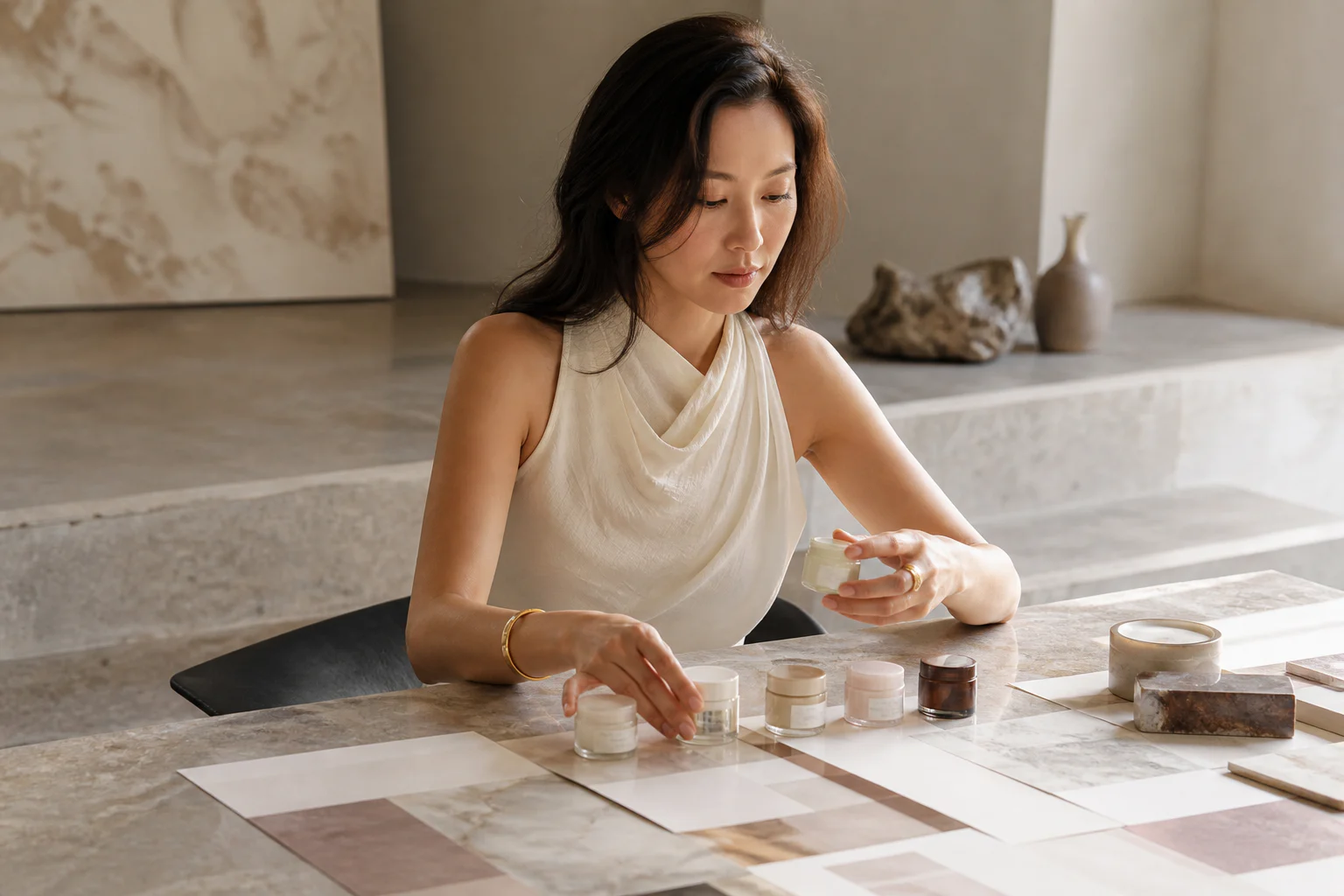 Fashion editorial beauty founder planning a focused skincare range with unbranded samples