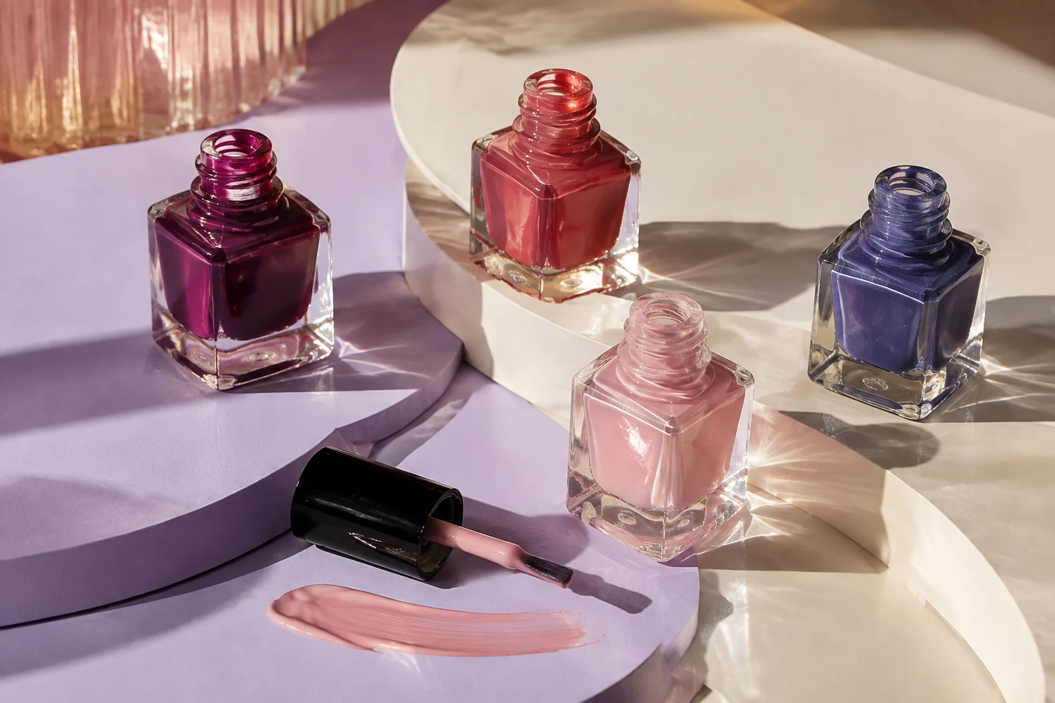 Plum, coral, pink and blue nail polishes on curved lilac display surfaces
