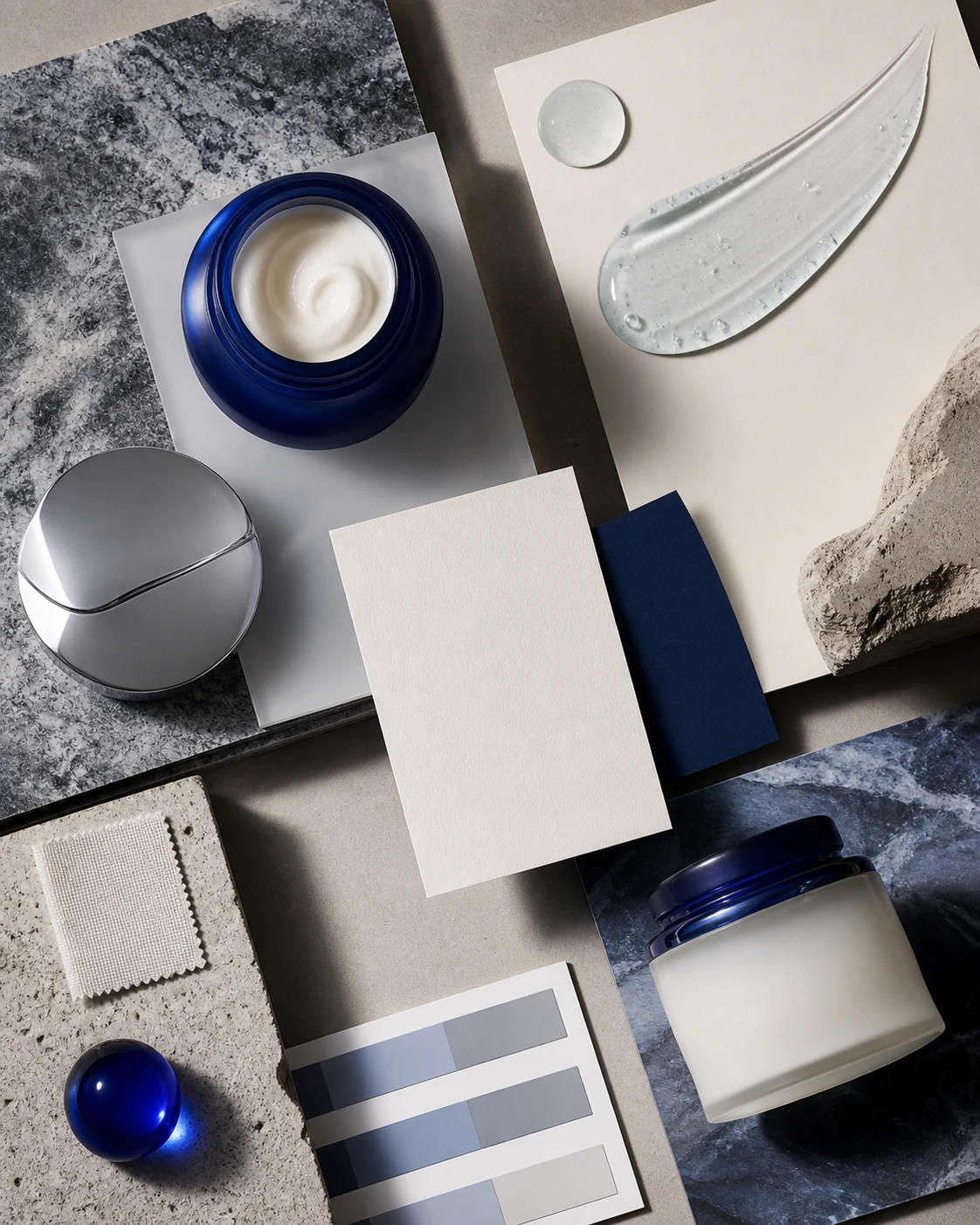 Luxury skincare concept board with cobalt jars, materials and translucent texture