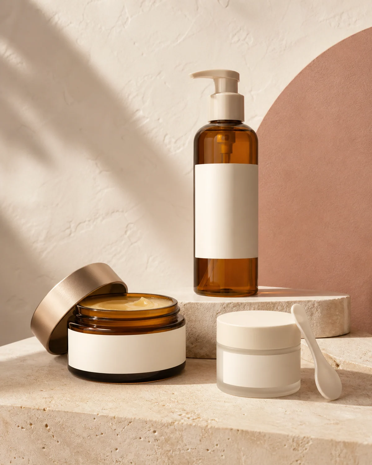 Unbranded amber cleansing balm jars and pump oil bottle on limestone